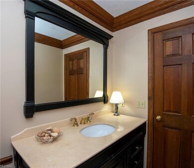Handy updated half bath is located off the Kitchen, Laundry & Library and is a quick run in from the three car garage
