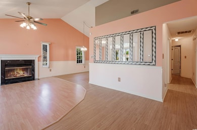 Unfurnished living room with a ceiling fan, visibl