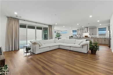 Living room with recessed lighting and light wood-type flooring