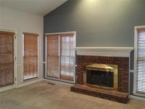 Unfurnished living room with high vaulted ceiling,