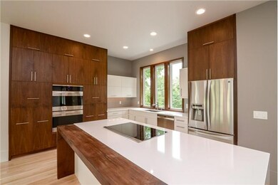 Custom kitchen features White Zeus Quartz Counter Tops and Kenmore Elite appliances with induction cooktop!