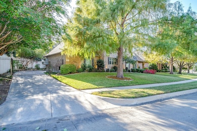 Obstructed view of property featuring a gate, driveway, and brick siding