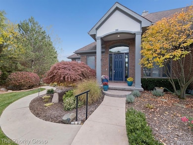 Doorway to property featuring brick siding and a shingled roof