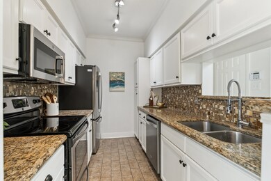 View of updated kitchen with painted cabinets, new