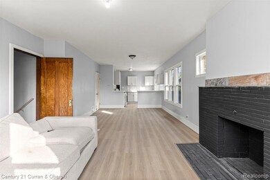 Unfurnished living room featuring light wood-style flooring and a fireplace with flush hearth