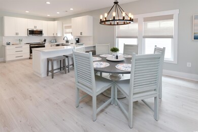 Dining space featuring sink, a chandelier, and lig