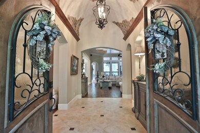 Be prepared to be Wow'd with the details in this house. The foyer features fabulous barrel ceiling with brick accents, wood crown molding and beautiful light fixture!