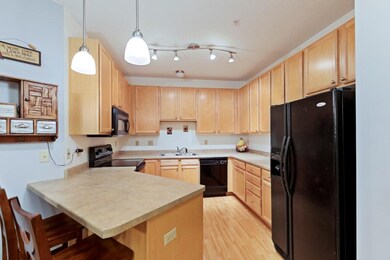 Kitchen boasts ample cabinetry and breakfast bar