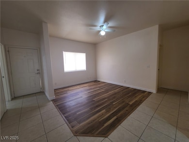 Spare room with a ceiling fan and light tile patte