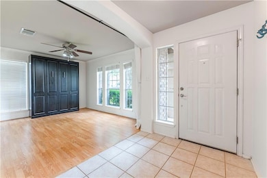 Foyer with light tile patterned flooring, ceiling