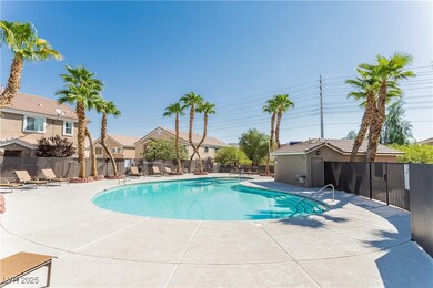 Community pool featuring a patio, fence, and a res