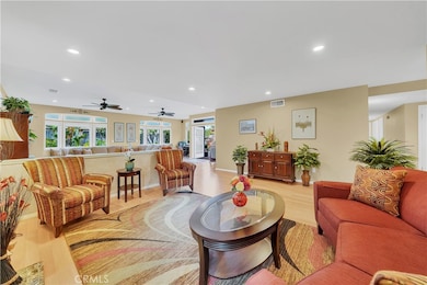 Formal Living Room and Adjacent Great Room with Bay Windows, Transom Windows and French Doors to Backyard