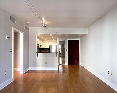 Unfurnished living room featuring dark wood-style flooring and recessed lighting