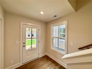 Entryway with dark wood-type flooring and baseboards