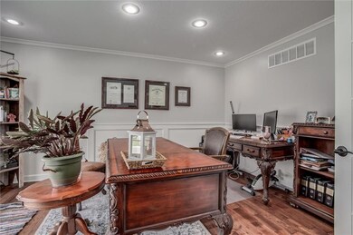 Office space featuring crown molding and hardwood / wood-style flooring
