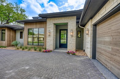 Property entrance with stone siding, an attached 