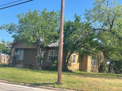 View of side of home with a yard