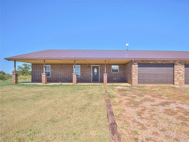 Single story home featuring a front yard and a gar