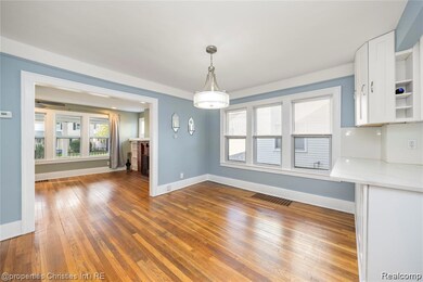 Unfurnished dining area featuring light wood-style flooring and a brick fireplace