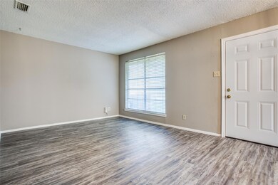 Spare room with visible vents, a textured ceiling