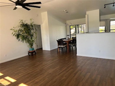 Dining room with dark wood finished floors and a ceiling fan