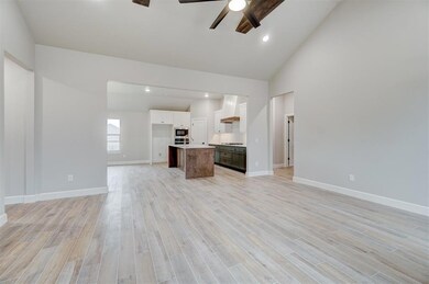 Unfurnished living room with high vaulted ceiling,