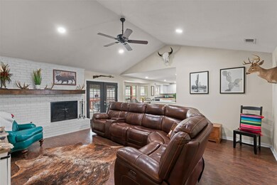 Living room with lofted ceiling, ceiling fan, a br