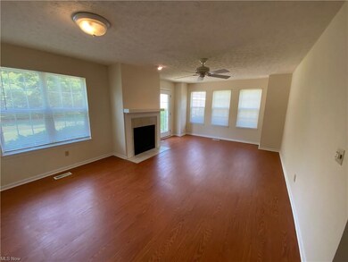 The large great room with a gas fireplace. The win