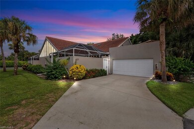 View of front of house featuring a yard and a gara