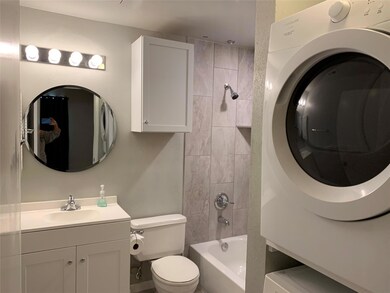 Full bath with washer / clothes dryer, vanity, to
