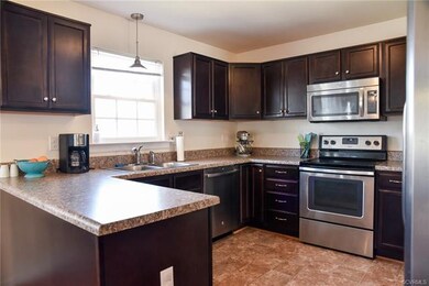 Spacious kitchen features rich maple cabinets with