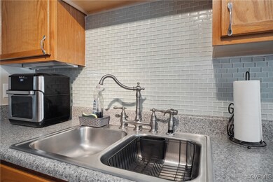 Kitchen featuring sink and backsplash