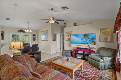 Living room featuring lofted ceiling, light tile p