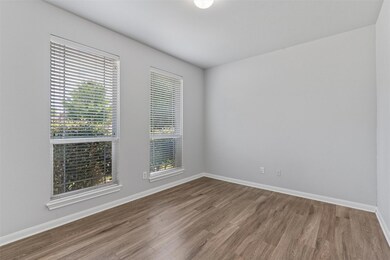 Unfurnished room with wood finished floors and ba