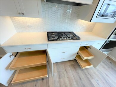 The stunning gourmet kitchen features a double wal