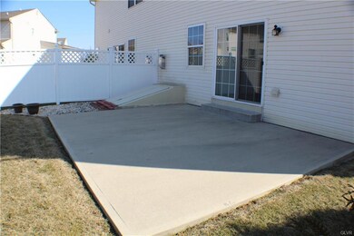 Concrete back patio next to the Bilco doors for th