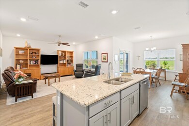 Kitchen with visible vents, a sink, gray cabinetry, light wood-style floors, and stainless steel dishwasher