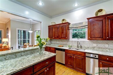 Modern kitchen opens to eating area and family roo