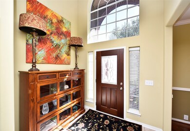 As you step through the updated front door with leaded glass insert, you take note of how well this home has been cared for with its soaring ceiling, impressive clerestory window and side lights that let the natural light cascade in. Tiled entry for easy clean up and a coat closet for all your jackets and storage.