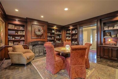The warm and cozy Library off of the entry has sol