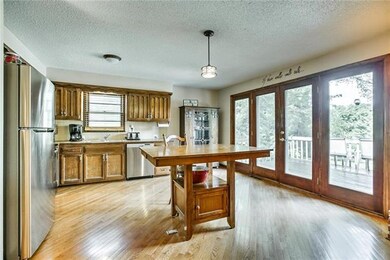 Wood floors extend into the kitchen.
