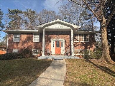 View of front of home with brick siding, a porch, 