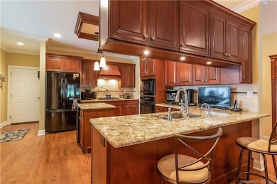 The heart of the home...this kitchen features warm cherry cabinetry, granite counters and more.