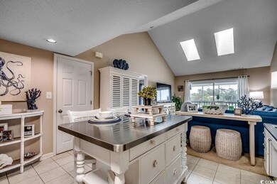 Kitchen with a center island, white cabinetry, dar