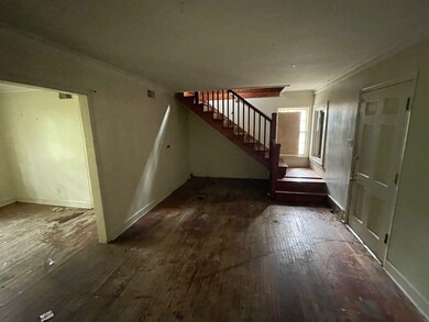 Foyer with hardwood / wood-style flooring, ornamental molding, stairs, and baseboards