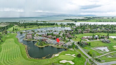 Aerial view of residential area featuring a water and mountain view and a local golf course