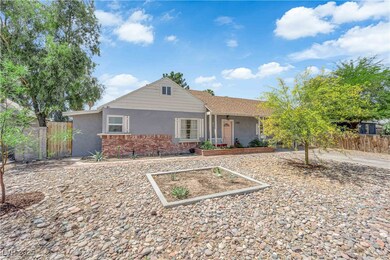 View of front of home with stucco siding and fence