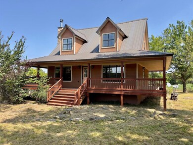 Country-style home featuring a porch and a front l
