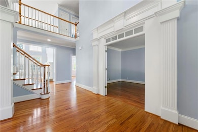 Entryway featuring baseboards, ornamental molding,