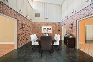 The large dining room with slate floor and high ce